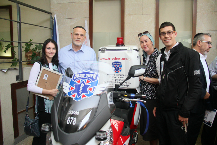 Daniel Vilfic's family standing with Daniel Shore at the ambucycle dedication ceremony.