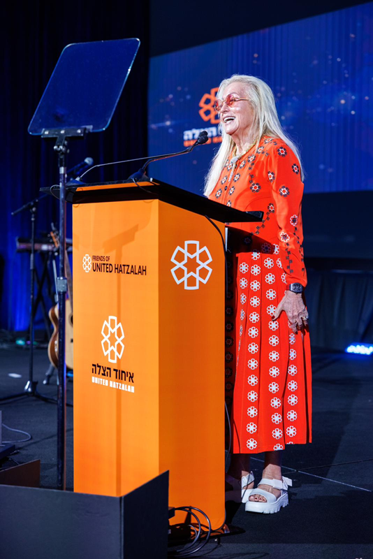 Dr Miriam Adelson wearing special dress designed by Tovale lower